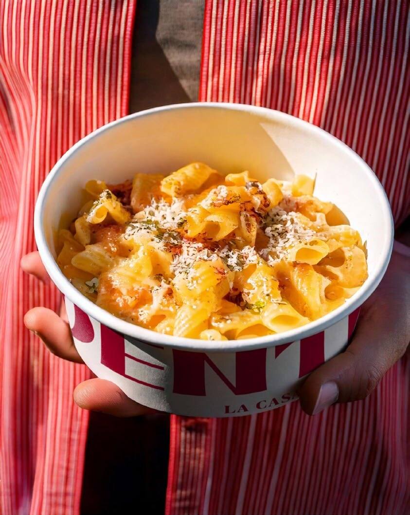 A branded Al Dente bowl of casarecce in rosé sauce with Parmigiano