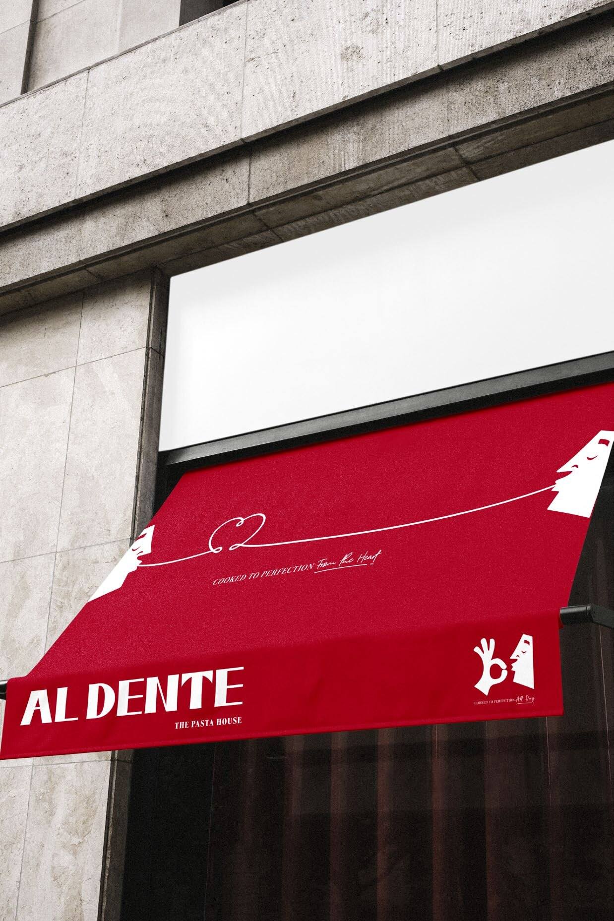 Red Al Dente awning on a stone storefront